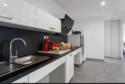 a kitchen with a sink and a refrigerator at Gite Mare e Montagne Drap 06 in Drap