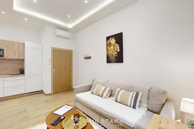 a living room with a couch and a table at Suite Gold FSHH in Nice