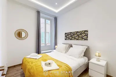 a white bedroom with a bed and a window at Suite Gold FSHH in Nice