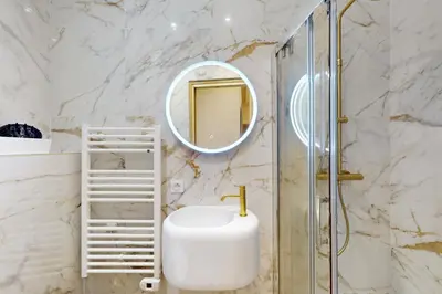 a bathroom with a sink and a shower at Suite Gold-Stars FSHH in Nice