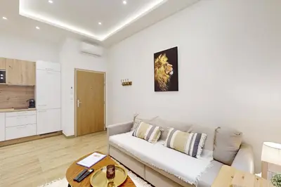 a living room with a couch and a table at Suite Gold-Stars FSHH in Nice