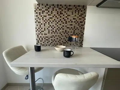 a table with two cups and two chairs at Magnifique appartement avec vue sur mer in Nice