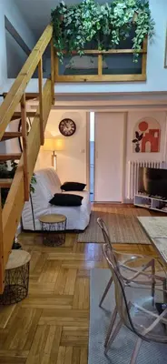 a living room with a staircase and a couch at Grand T1 proche Promenade des Anglais in Nice