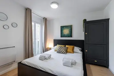 a bedroom with a large bed with two pillows on it at Walesa- wifi, AC, 3 pers in Nice