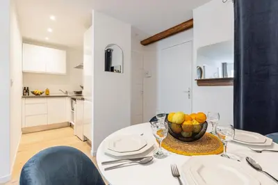 a dining room table with a bowl of fruit on it at Walesa- wifi, AC, 3 pers in Nice