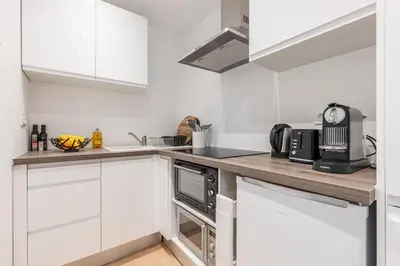 a kitchen with white cabinets and a counter top at Walesa- wifi, AC, 3 pers in Nice