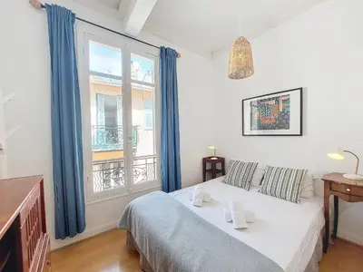 a bedroom with a bed and a large window at Nestor&Jeeves - PROVENCAL - Central - Near Beach in Nice