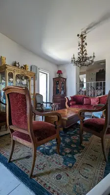 a living room with a couch and a table and chairs at Maison de 6 pièces au coeur du village d'Eze in Èze