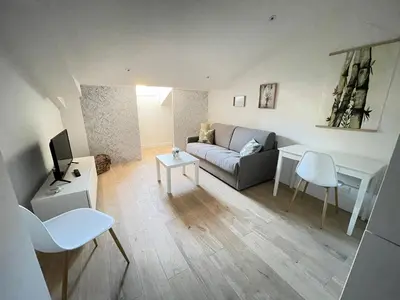 a living room with a couch and a table at COMBOUL in Nice