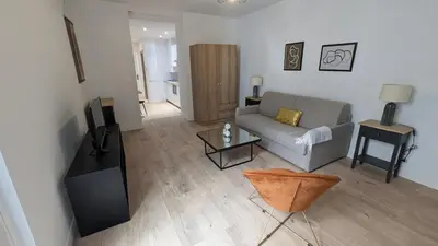 a living room with a couch and a table at COMBOUL in Nice