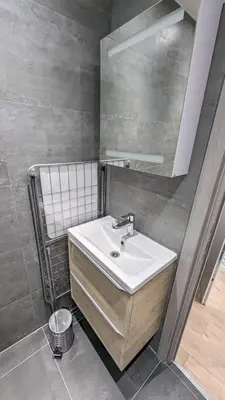 a bathroom with a sink and a mirror at COMBOUL in Nice