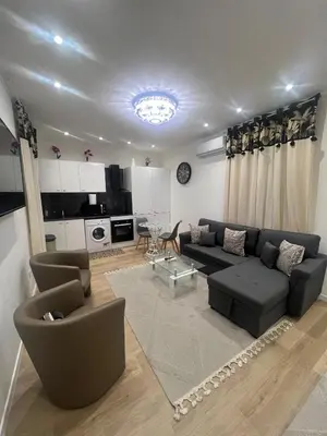 a living room with a couch and a table at Appartement T2 in Nice