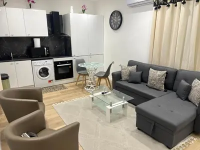 a living room with a couch and a table at Appartement T2 in Nice