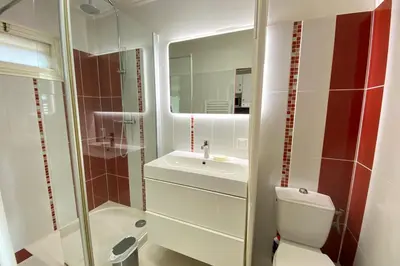 a bathroom with a toilet and a sink and a mirror at 06BH - Beautiful seafront studio in Saint-Laurent-du-Var