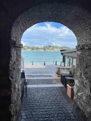 a stone archway with a view of the beach at Loft - centre historique in Villefranche-sur-Mer
