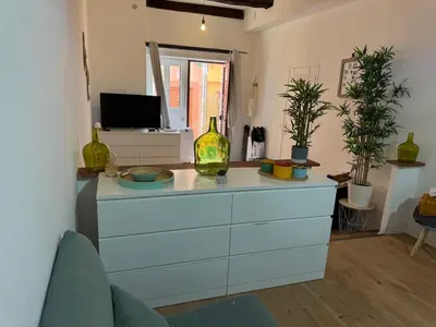 a kitchen with a blue dresser with vases on it at Loft - centre historique in Villefranche-sur-Mer