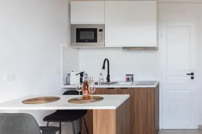 a white kitchen with a sink and a counter top at L33 2P Jean Médecin centrale/ 2 Balcony & AC in Nice