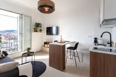 a kitchen and living room with a counter and a sink at L33 2P Jean Médecin centrale/ 2 Balcony & AC in Nice