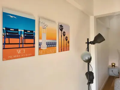a room with three pictures on the wall at #TheCosyStudio06 Meyerbeer Promenade Negresco in Nice