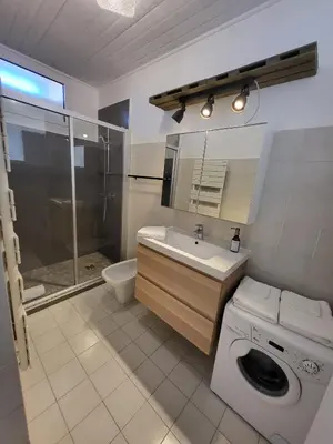 a bathroom with a washing machine and a sink at #TheCosyStudio06 Meyerbeer Promenade Negresco in Nice