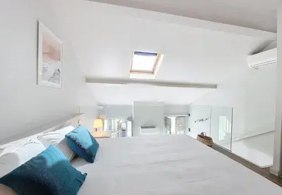 a white room with a bed with blue pillows at Nestor&Jeeves - ECLAT NICOIS - Central - Near beach in Nice
