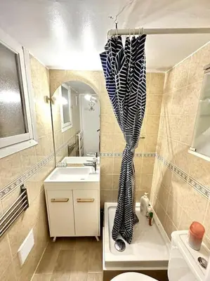a bathroom with a toilet and a sink at La Tanière du Bois Flotté in Nice