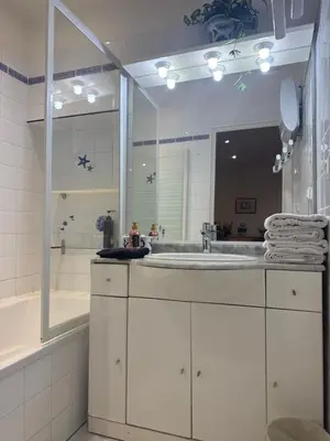 a bathroom with a sink and a large mirror at Le ville franche in Villefranche-sur-Mer