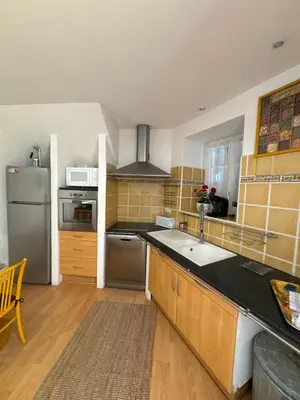 a kitchen with a refrigerator and a counter top at Le ville franche in Villefranche-sur-Mer