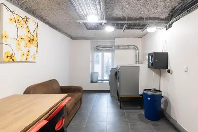 a room with a couch and a table and a kitchen at Résidence de l'Alliance in Nice