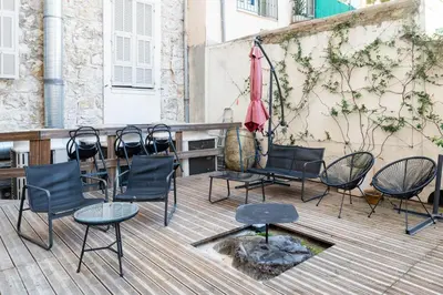 a group of chairs and an umbrella on a deck at Résidence de l'Alliance in Nice