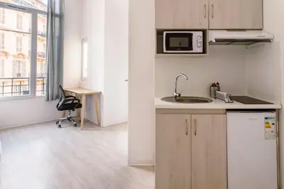 a kitchen with a sink and a microwave at Résidence de l'Alliance in Nice