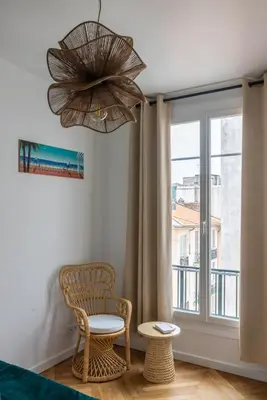 a room with a window and a chair and a window at Serenity chic apartment Nice center in Nice
