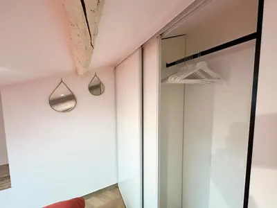 a room with a glass door and two lights on the wall at Elegant mansardé-place du pin in Nice