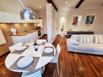 a kitchen and living room with a white table and chairs at 
