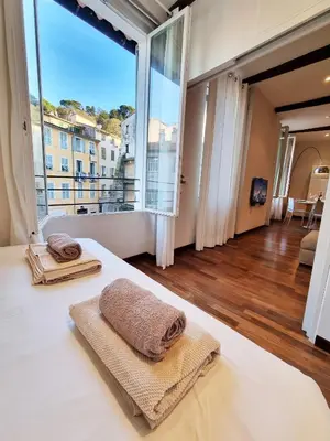 a bedroom with a bed and a large window at 
