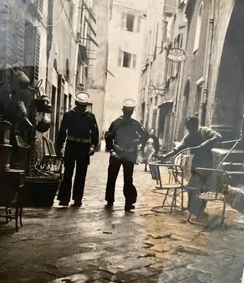 a group of three police officers walking down a street at Logement Atypique in Villefranche-sur-Mer