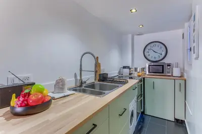 a kitchen with a sink and a clock on the wall at LA TREILLE AP4334 By Riviera Holiday Homes in Nice