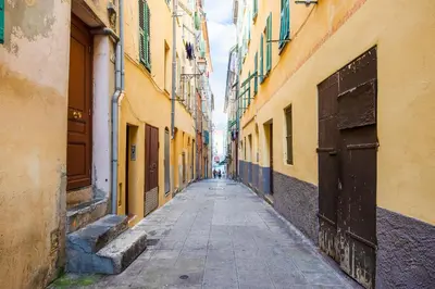 an empty alleyway between two buildings in a city at LA TREILLE AP4334 By Riviera Holiday Homes in Nice