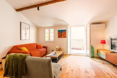 a living room with a couch and a tv at LA TREILLE AP4334 By Riviera Holiday Homes in Nice