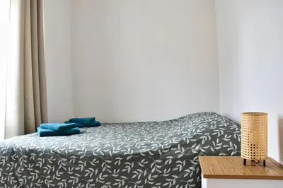 a bedroom with a bed with blue towels on it at Bel appartement au cœur de Nice (2 chambres) in Nice