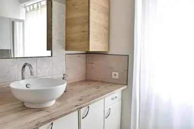 a bathroom with a white sink and a mirror at Bel appartement au cœur de Nice (2 chambres) in Nice