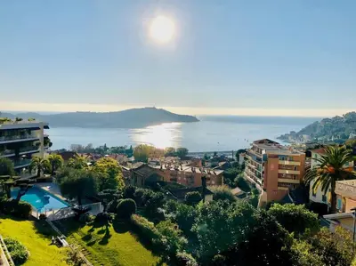 a view of the ocean from a city with buildings at Appartement „Bellevue“ Villefranche-sur-Mer in Villefranche-sur-Mer