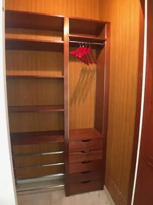 a wooden closet with a red umbrella in it at Appartement „Bellevue“ Villefranche-sur-Mer in Villefranche-sur-Mer