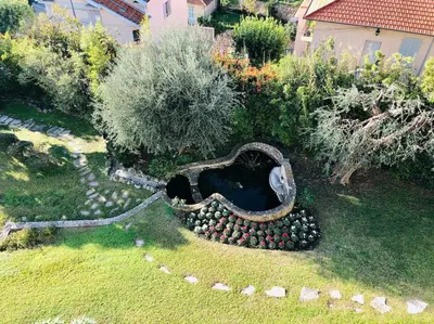 a garden with a heap of balls in the grass at Appartement „Bellevue“ Villefranche-sur-Mer in Villefranche-sur-Mer