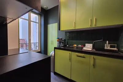 a kitchen with green and black counters and a window at Close to the beach behind the famous Negresco ! in Nice