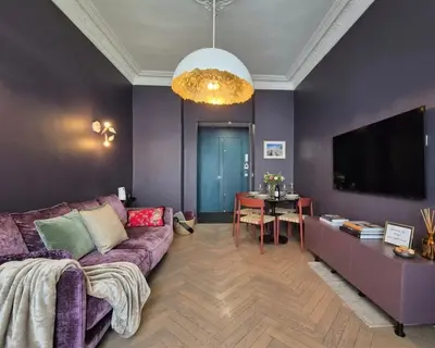 a living room with a purple couch and a table at Close to the beach behind the famous Negresco ! in Nice