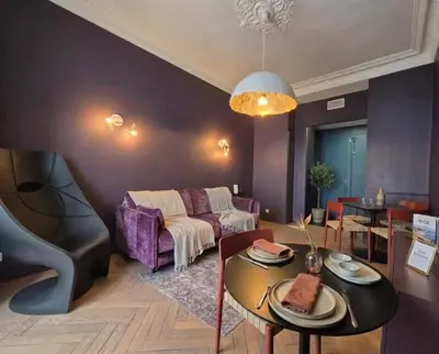 a bedroom with a large bed and a chandelier at Close to the beach behind the famous Negresco ! in Nice