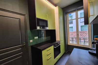 a bathroom with a green tiled shower with a window at Close to the beach behind the famous Negresco ! in Nice