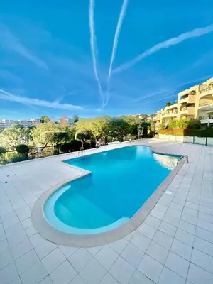 a large swimming pool with a blue at Nice Ouest- 2P au Calme, Piscine, AC in Nice