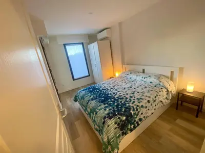 a small bedroom with a bed and a window at Nice Ouest- 2P au Calme, Piscine, AC in Nice